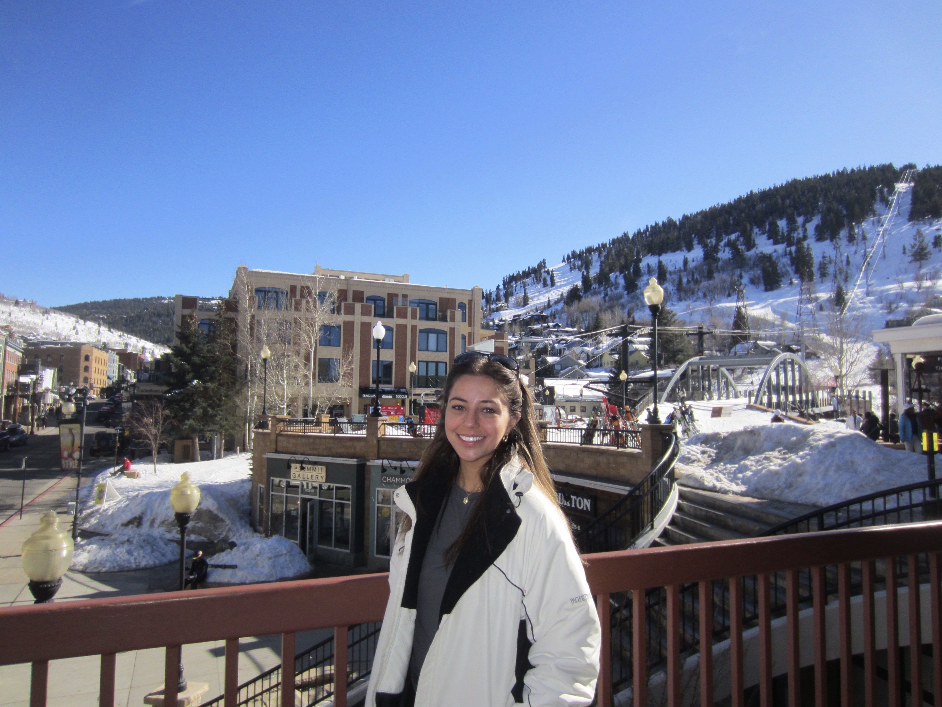 Olivia posing in front of snow and buildings